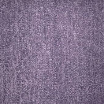 Lavender fabric texture sample with granular weave, displaying “moroso hyle 210 lavender – q” text, studio lighting.